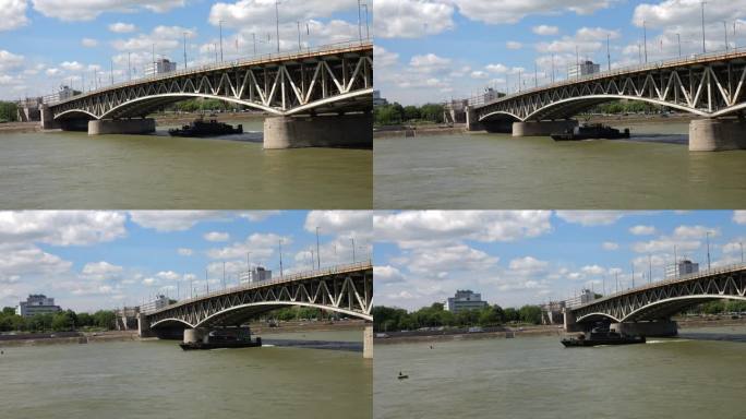军用船只在多瑙河上巡逻，Petőfi桥和河流西岸的景色，布达在布达佩斯，匈牙利。