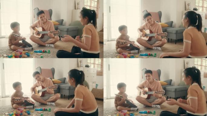 家庭学习:亚洲父子在音乐中寻找快乐，微笑着弹吉他。