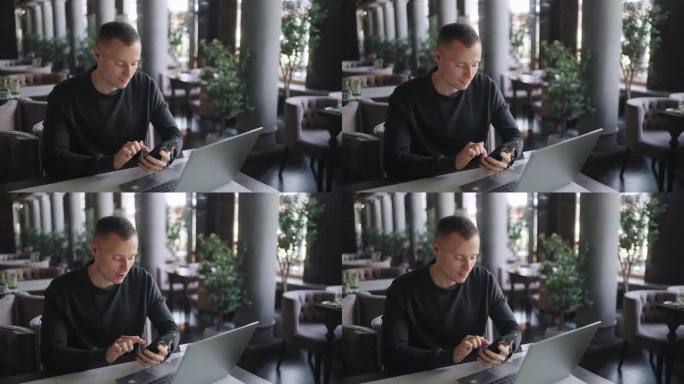 男性用户在咖啡馆用智能手机和笔记本电脑，自由职业者用手机上网