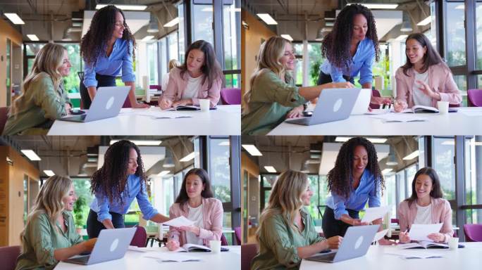 多文化女性商务团队在现代办公室用笔记本电脑开会，慢镜头拍摄