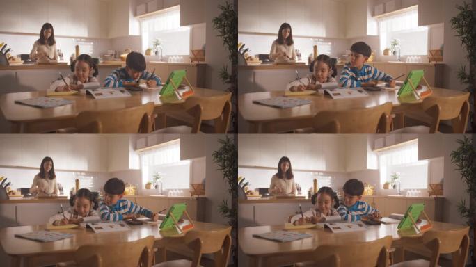 在妈妈准备早餐的时候，坐在餐桌边画画写字的韩国孩子的肖像。上学前等待营养餐的可爱小朋友