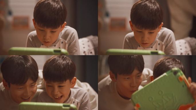 体贴的亚洲男孩在孩子的卧室里用平板电脑玩电子游戏。年轻的父亲来到房间给他的可爱的天才儿子惊喜和花时间