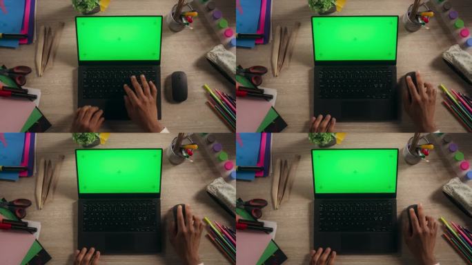 匿名非洲设计师在笔记本电脑上打字，模拟绿屏Chromakey显示。黑色插画师使用计算机，工作在一个数