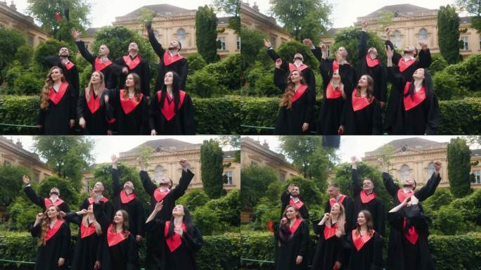 兴奋的学生，毕业生，高兴的扔毕业帽，在大学的花园里，他们都感觉很好