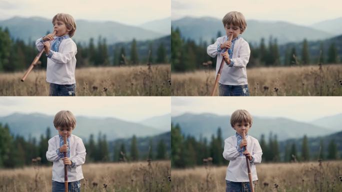 民间音乐概念。穿着传统刺绣衬衫的小孩。小男孩在喀尔巴阡山脉的草地上演奏木管木笛-乌克兰索皮卡。