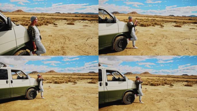 一名妇女用双筒望远镜观察摩洛哥的沙漠和山脉