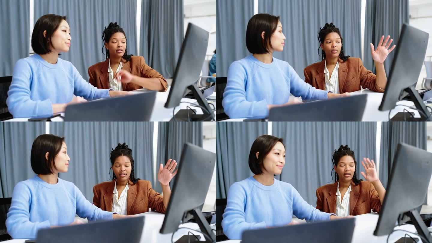 两个女程序员在电脑上讨论软件编码