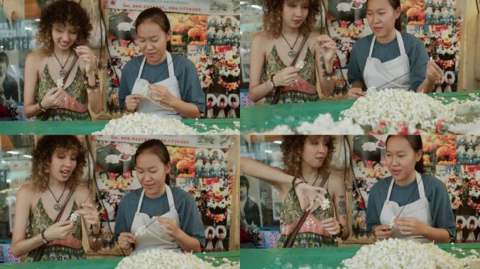 花店企业家亚洲妇女教一名女游客在她的店里自己制作花环。