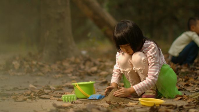 小女孩在公园玩泥沙