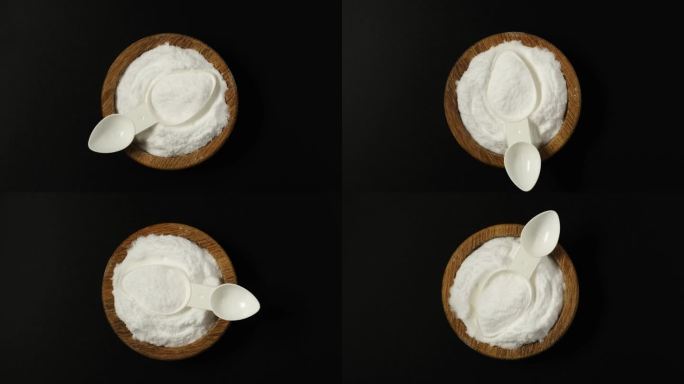 一水葡萄糖粉末，d-葡萄糖或葡萄糖在木碗与测量勺，俯视图。天然甜味剂，代糖。视频4K，旋转