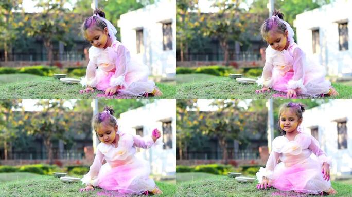 女婴在公园外面用粉彩玩胡里节
