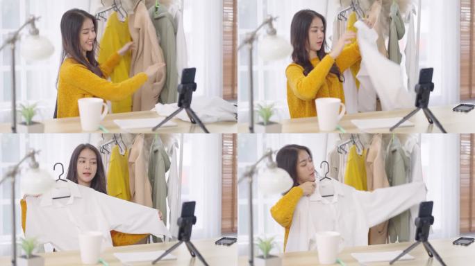 亚洲女时装设计师用手机直播展示服装进行网络营销。