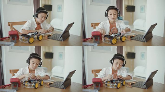 男孩在网络实验室里玩和驾驶他的机器人汽车。干教育