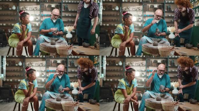 在陶艺工作坊的大师课上，资深陶工与学生一起准备制作陶轮所需的粘土