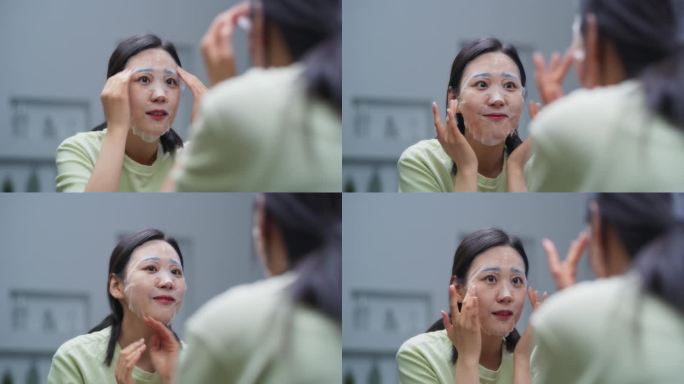 迷人的韩国女性在家里使用面部补水面膜作为她护肤程序的一部分。美丽的年轻亚洲女人关心她的健康和自然的美