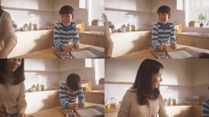 一个韩国女人和她的儿子在家里的厨房里的肖像:美丽的母亲准备做午餐，同时和她旁边做作业的可爱的孩子说话