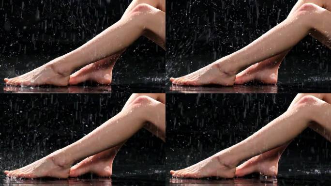 在暗室里的人造雨下，湿了女人纤细的腿