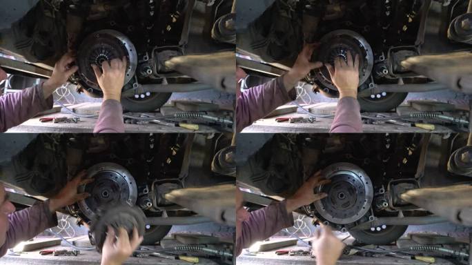 机械师修理汽车的离合器。