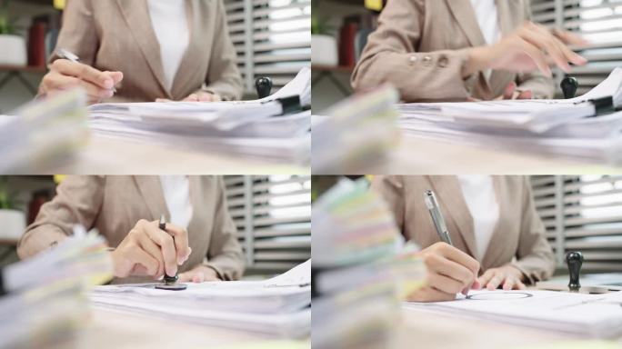 女律师或法官在法庭上做笔记的手特写，律师业务在桌子办公室工作。