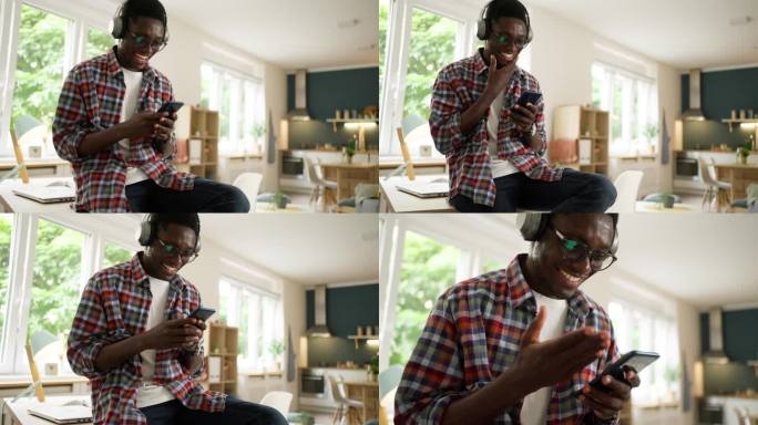 现代非洲裔美国人一边用手机一边用无线耳机听音乐