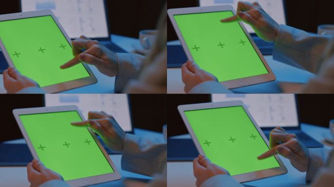 女子手持平板电脑与绿色屏幕和滑动