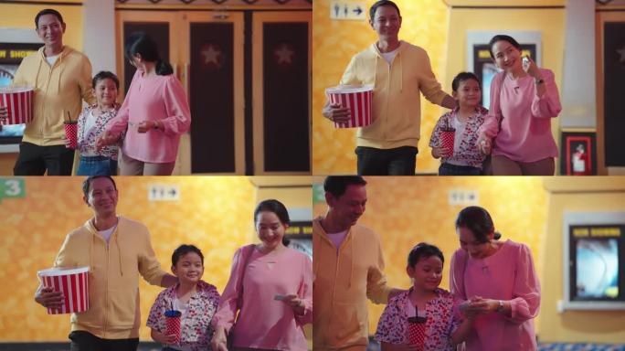 亚洲父亲和母亲周末带女儿去电影院看电影。快乐的亚洲家庭拿着电影票，爆米花和饮料去电影院看电影。家庭活