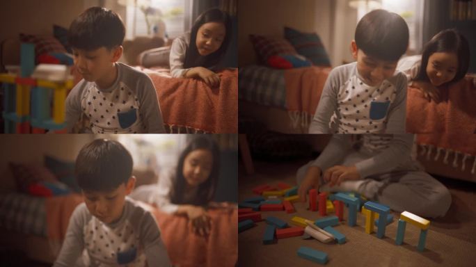 一个专注的小男孩在玩积木，而他聪明的小妹妹在儿童房看着他。快乐的韩国孩子聚在一起笑