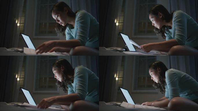 亚洲女性晚上在笔记本电脑前工作