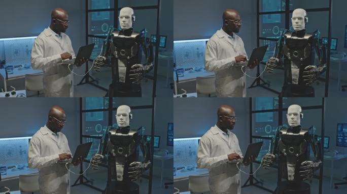 工程师在实验室中连接人类机器人和笔记本电脑