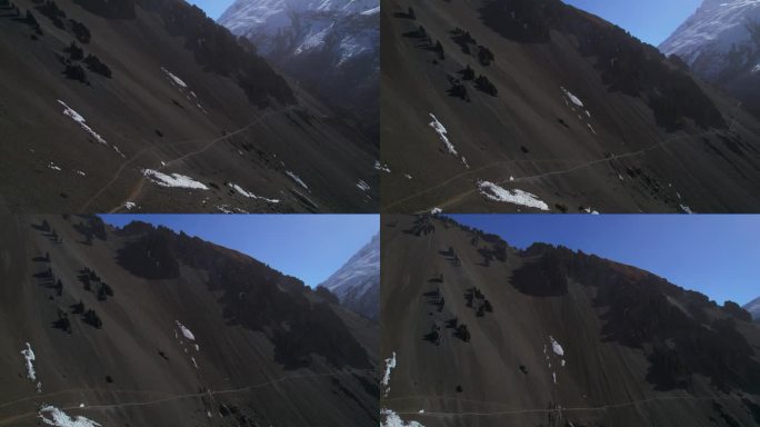 空中鸟瞰四名徒步旅行者在喜马拉雅山脉的蒂里科大本营徒步旅行。徒步探险，游客在导游的带领下安全地在尼泊