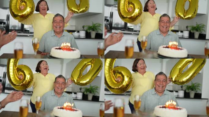 朋友和妻子在家里唱生日快乐歌庆祝一位老人的生日