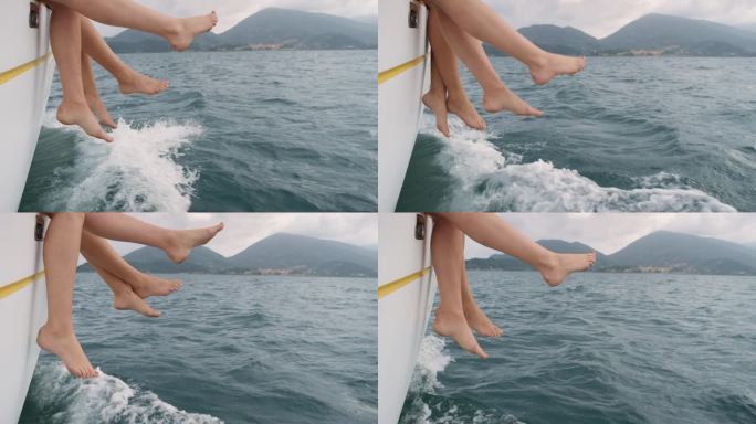 女朋友的腿挂在边缘帆船在海洋上奢侈的生活方式快乐的冒险旅行度假