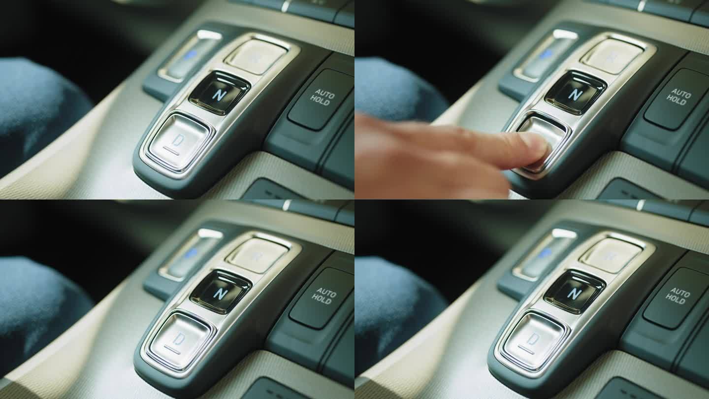 启动汽车引擎。跟踪按钮。手指按下按钮启动汽车发动机。一个现代汽车驾驶模式选择按钮的特写镜头，在中控台