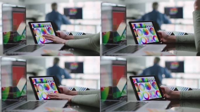 女设计师在平板电脑上研究色彩光谱的剪影
