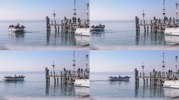 宁静的场景在西尔米奥内码头与船只停泊在码头