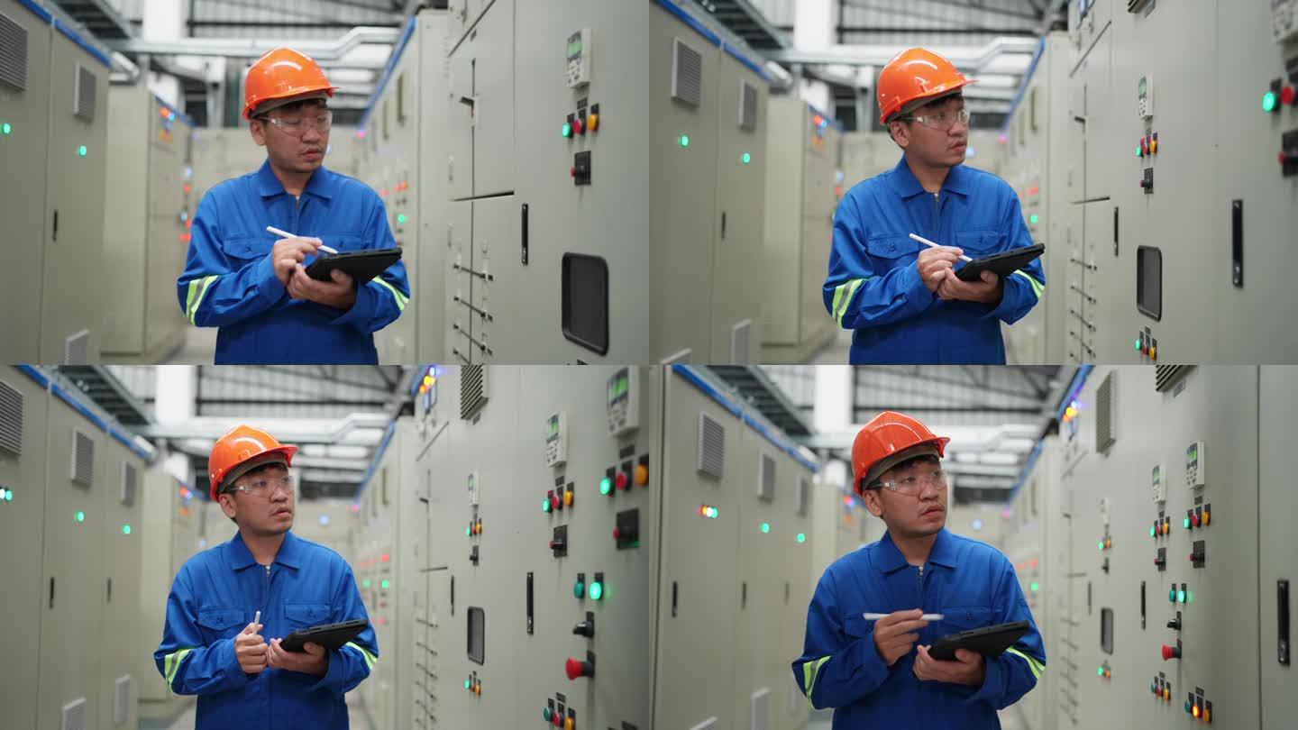 电气工程师在工厂的控制室里努力工作。利用数字平板电脑，利用Wi-Fi技术的力量。专业检查和监控电气系