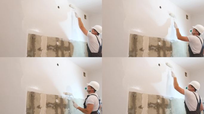 建筑工人把墙漆成白色。那个人正在修理房间。房子的内饰很现代。