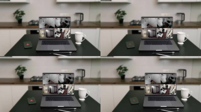 桌上笔记本电脑屏幕上的现代监控摄像头。家庭安防系统