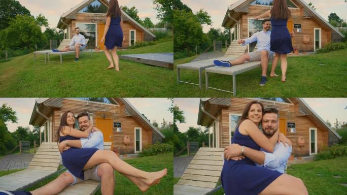 一个女人跑向一个男人，抱着他坐在度假别墅外的躺椅上