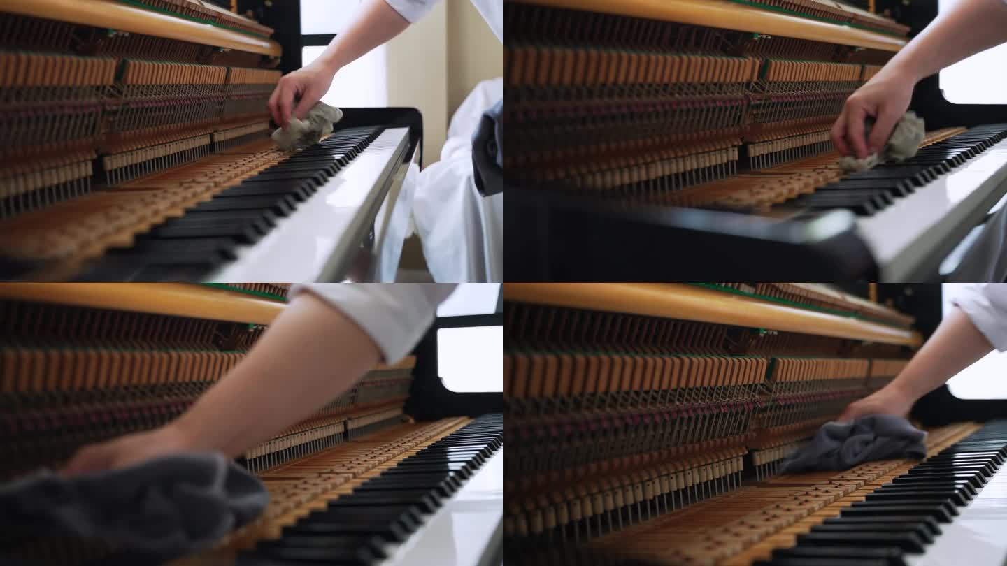 专业维修人员和音乐调音师的手在清理打开的钢琴。