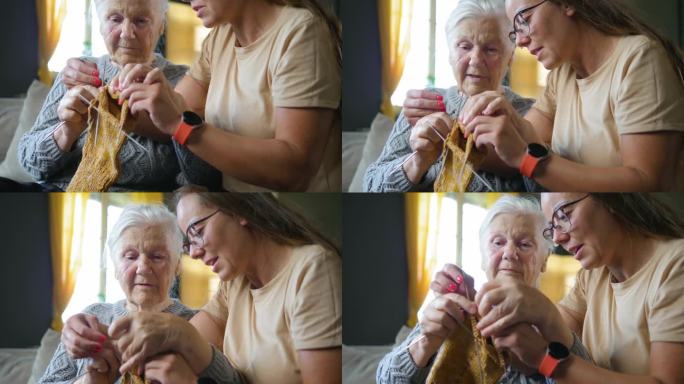 80年代的老妇人教专注的孙女如何用毛线编织。