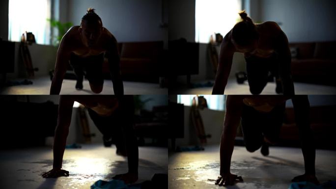 慢镜头:身材匀称、光着膀子的年轻人在做登山运动，在家里客厅的地板上汗流浃背。奉献，自我提升，健康生活
