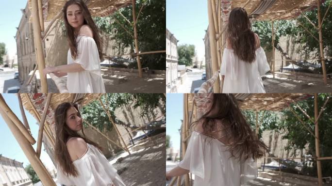 一位飘逸长发的年轻女子身穿白色背心裙，在芦苇丛下走过一座古城