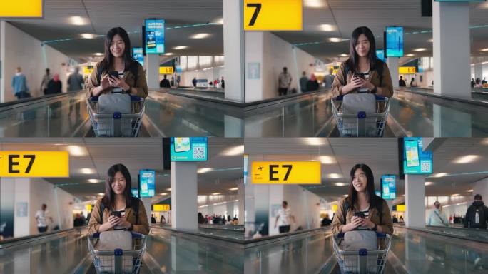 在机场人行道自动扶梯上使用手提电话的亚洲女旅客