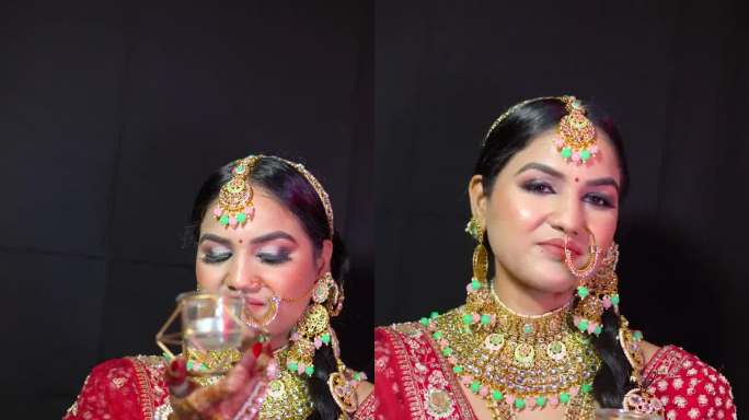美丽的印度女人穿着新娘的装束，戴着lehanga和珠宝。