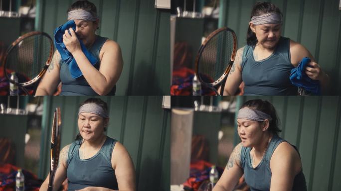 亚洲华人女子网球运动员赛后用毛巾擦汗
