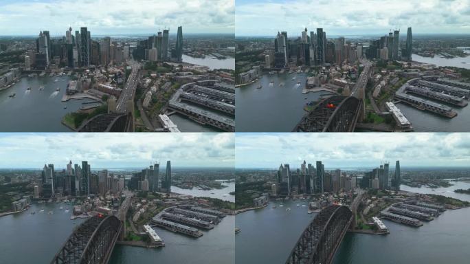 日出时悉尼中央商务区上空的4K鸟瞰图，有各种现代办公大楼和歌剧院。