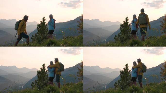 一对徒步旅行的老年夫妇从山顶往外看