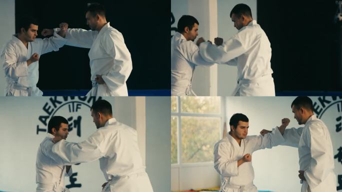 在武术学校，跆拳道大师向学生展示如何挡拳