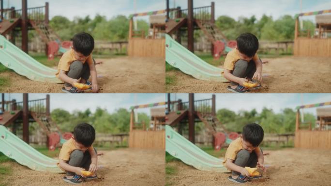 快乐的亚洲男孩在户外游乐场的沙盒冒险中释放创造力。